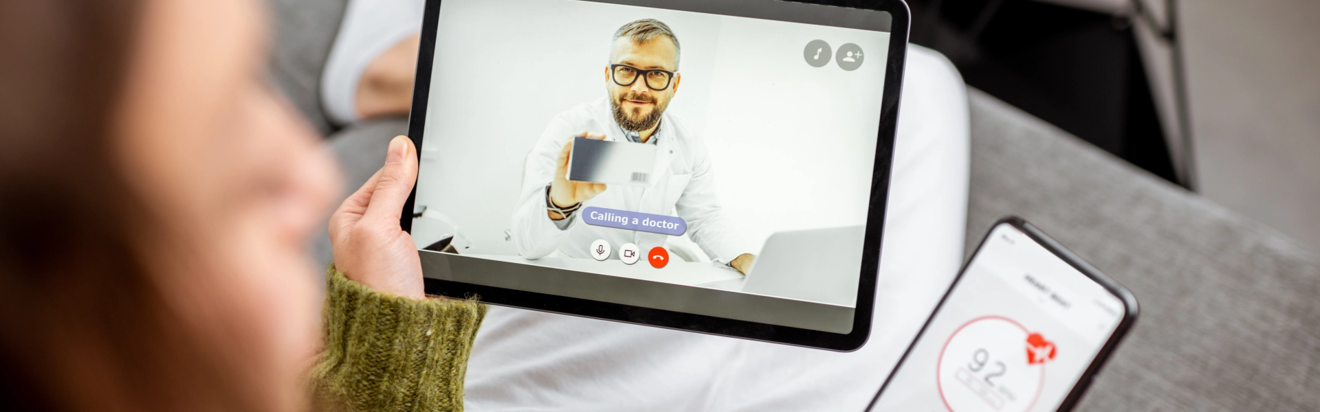male doctor talking to a female patient through video call